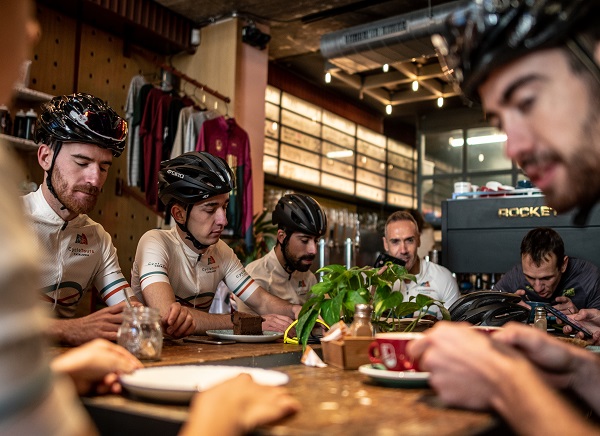 Cyclist taking a cofee in a Cafè